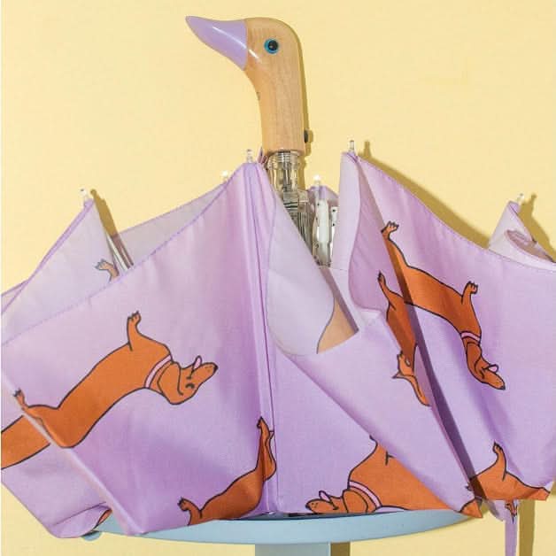 Umbrella with dachshund pattern on a yellow background